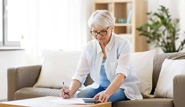 Elderly woman sitting on sofa